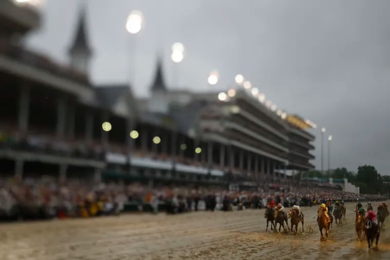 In this photo made with a tilt shift lens, Luis Saez rides Maximum Security across the finish line first during the 145th running of the Kentucky Derby. Country House was declared the winner after Maximum Security was disqualified following a review by race stewards.