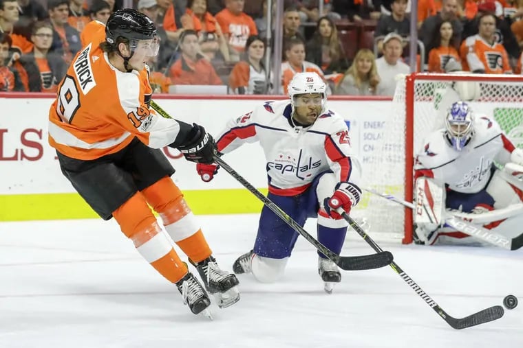 Flyers center Nolan Patrick passes the puck against Capitals right wing Devante Smith-Pelly on Saturday.