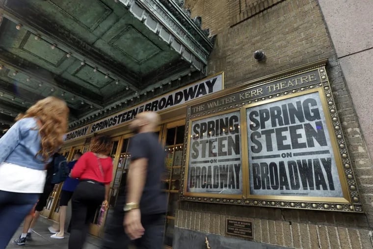 People pass the Walter Kerr Theater, home to the Broadway show &quot;Springsteen on Broadway,&quot; in New York's Theater District. The upcoming show will be the one of the latest to offer up tickets for sale using new technology, called Verified Fan, to try to keep re-sellers and brokers from snapping them all up.