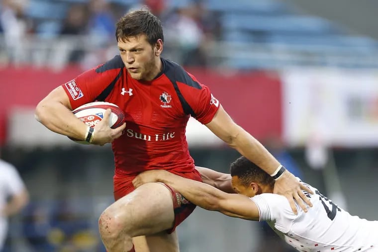 Canada's Adam Zaruba, left, is tackled by England's Dan Norton during the Tokyo Sevens rugby tournament in Tokyo in April.