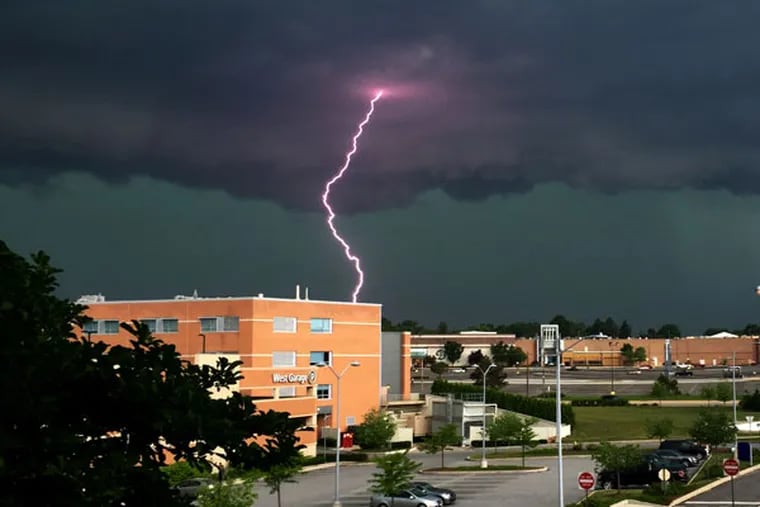 Lightning strikes over Riddle Hospital in Middletown Township, Delaware County, as a severe thunderstorm rolls through the area. Some areas were under a tornado warning, although no such clouds were confirmed. (STACEY FRITZ/For The Inquirer)