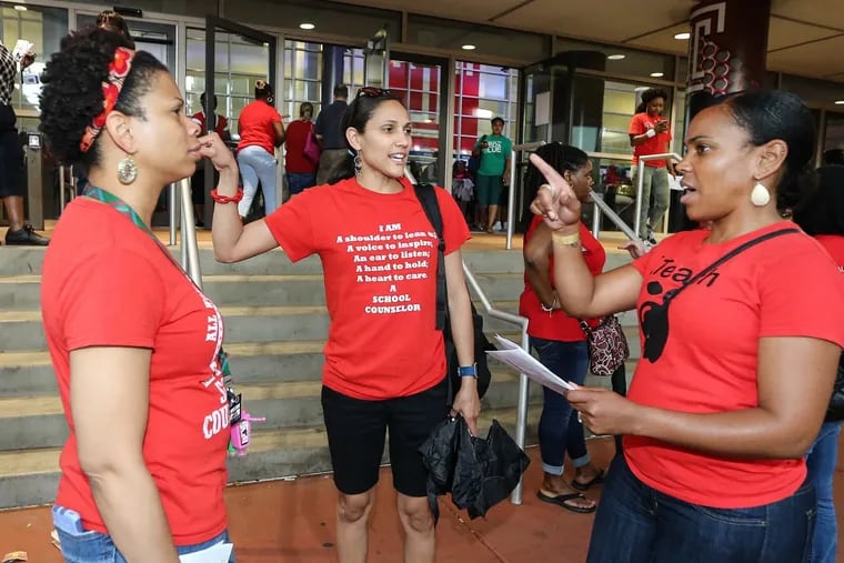 After voting on Monday, Christina Green (left), Ninoska Wong Shing (center),  and Sonya Salandy discuss the three-year contract.