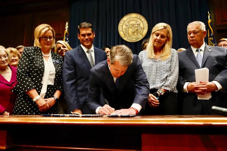Gov. Brian Kemp signs House Bill 481, which outlaws most abortions once a doctor can detect a fetus' heartbeat — usually around six weeks of pregnancy, on May 7, 2019.