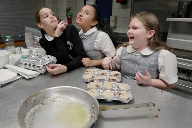 Ariella Kerrin (left) and Irene Haro goof around as Bailey Carr (right) looks on while the group was finishing the dessert during the My Daughter's Kitchen class at Blessed Trinity Catholic School, 3033 Levick St. in the Mayfair section of Phila. on November 22, 2019.