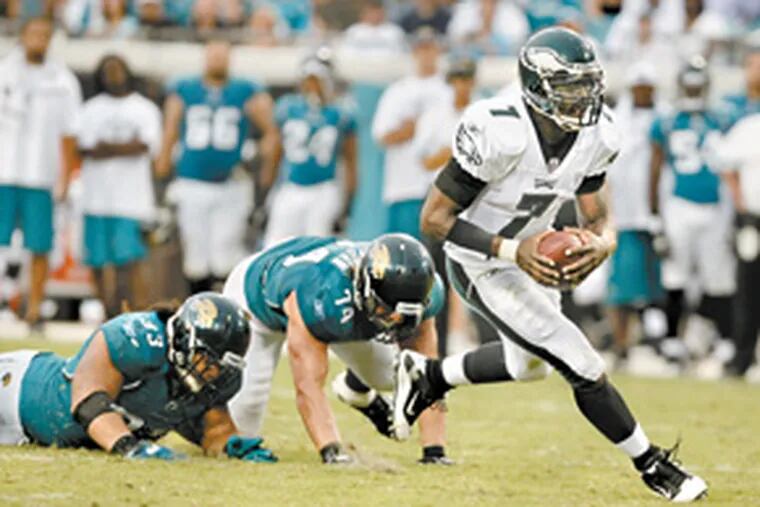 Michael Vick was too quick for Jacksonville’s defenders on a 17-yard touchdown run in the third quarter. Vick also threw three touchdown passes as the Eagles improved to 2-1 with the win in Jacksonville, Fla. (Ron Cortes / Staff Photographer)