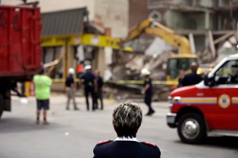 Lynda Raines with the Salvation Army views the demolition of one of their stores in the aftermath of a fatal building collapse in 2013. Nearly a decade later, an inspector shortage in the city's Department of Licenses & Inspections is raising safety concerns.