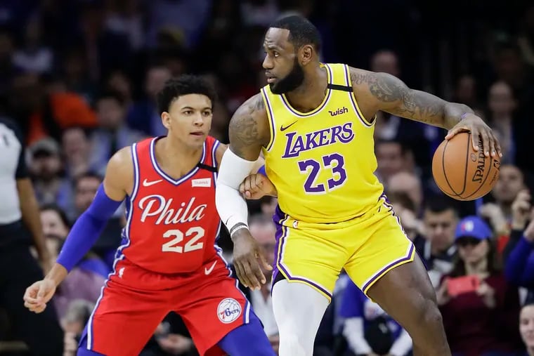 Los Angeles Lakers forward LeBron James dribbles the basketball defended by Sixers guard Matisse Thybulle on Saturday, January 25, 2020 in Philadelphia.
