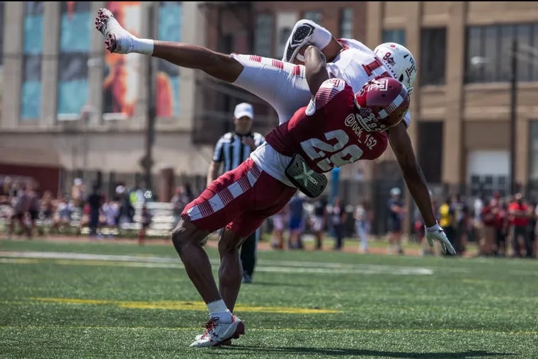 Cherry team's cornerback Rock Ya-Sin (right) picks up White team's wide receiver Ventell Bryant and throws him to the ground during Temple's Cherry and White spring football game at the Temple Sports Complex on Saturday, April 14, 2018. SYDNEY SCHAEFER / Staff Photographer