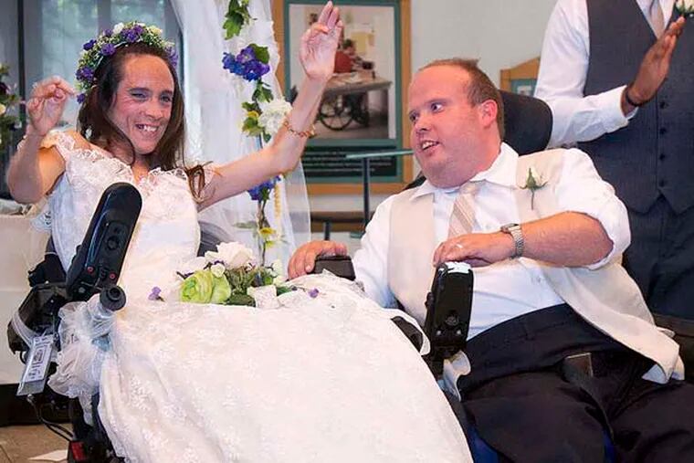 fMelinda Orth and Craig Stephens  celebrate after they are officially married at Inglis  House , a residence for  disabled adults, Craig has spin bifida and Melinda is a paraplegic. The ceremony took place on Saturday July 20, 2013. ( Ed Hille / Staff Photographer )