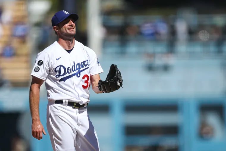 Max Scherzer (31) of the Los Angeles Dodgers reacts to fans cheering while going for his 3000th strikeout in the fifth inning against the San Diego Padres at Dodger Stadium on September 12, 2021 in Los Angeles, California.