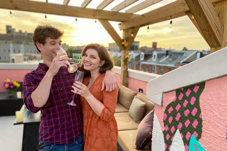 Nicolas Wilhelm and Sara Shuman celebrate their engagement on their West Poplar roof deck in June.