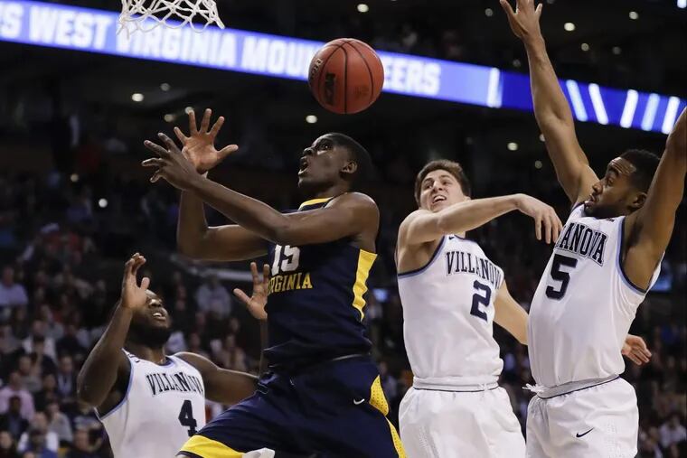 West Virginia forward Lamont West loses the basketball against Villanova forward Eric Paschall (left), guard Collin Gillespie and guard Phil Booth (second right) during the first half of Villanova’s win.