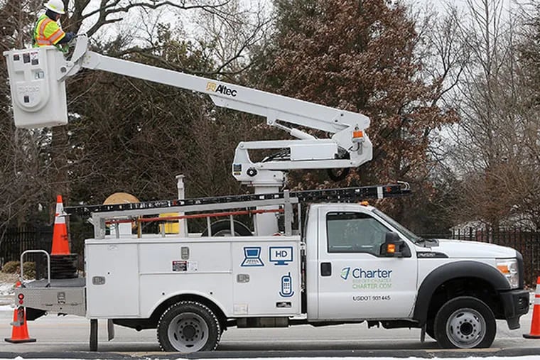 Charter Communications lead system technician Jim Norris uses a bucket truck to look for noise interference in an overhead cable line, Jan. 17, 2014, in Overland, Mo. (Stephanie S. Cordle/St. Louis Post-Dispatch/MCT)