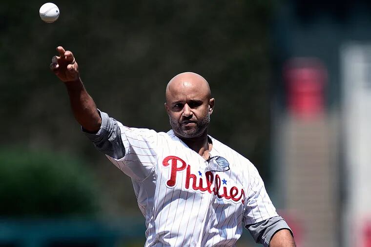 Former Philadelphia Phillies player Pacido Polanco throws out a ceremonial first pitch before a baseball game against the Colorado Rockies on Sunday, Aug. 14, 2016, in Philadelphia.