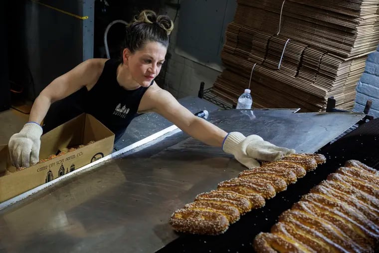 Erika Tonelli Bonnett, owner of Center City Soft Pretzel Co., boxing pretzels as they emerge from the oven.