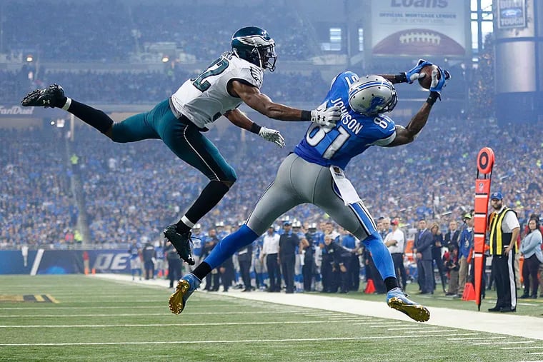 Lions wide receiver Calvin Johnson is defended by Eagles cornerback Eric Rowe.