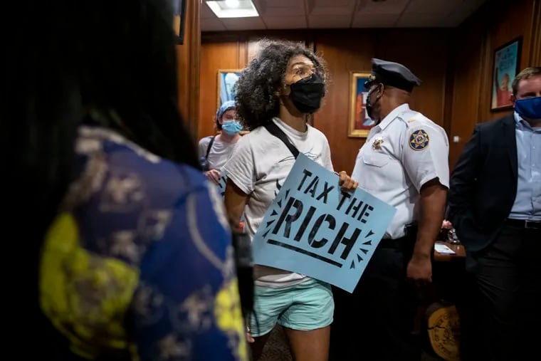 Sam Rise exits Mayor Jim Kenney's office with other protesters from the progressive group Reclaim Philadelphia and other organizations after staging a sit-in at the City Hall office in Philadelphia on June 8. Protesters called for no tax cuts in the ongoing budget negotiations and more investment in Black and brown communities.