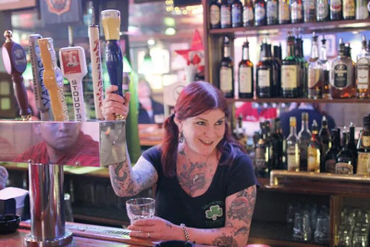 Kristie Matt pulls a draft beer at Brownie's Irish Pub in Old City. City Councilwoman Blondell Reynolds Brown is proposing to let bars stay open an extra hour. (Michael S. Wirtz / Staff Photographer)