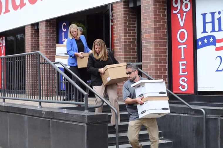 FBI employees carry out boxes from the Spring Garden Street offices of the International Brotherhood of Electrical Workers Local 98 in Philadelphia on Aug. 5, 2016. The first criminal charges in the investigation were revealed Monday with a guilty plea from a New Jersey electrical contractor with longstanding ties to both the union and its leader, John J. Dougherty.