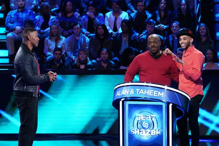 "Beat Shazam" host Jamie Foxx (left) with contestants Alan (center) and Taheem in the episode that aired Monday, June 10. After the two men won, it was revealed that Alan had died some time after the taping.