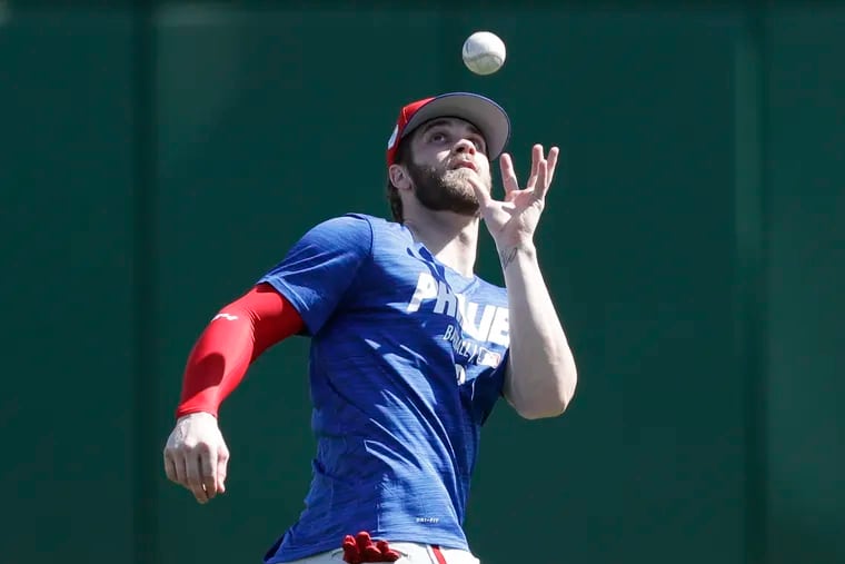 Bryce Harper does drills during his first practice with the Phillies.