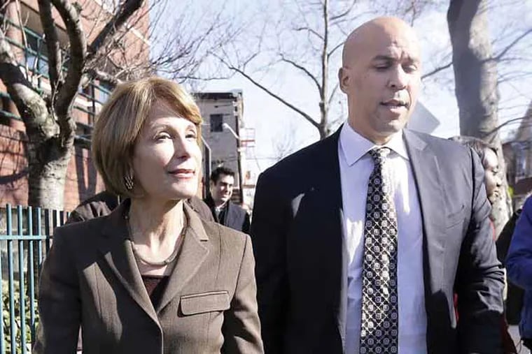 New Jersey Democratic Sen. Barbara Buono, left, walks with Newark Mayor Cory Booker during a walk through Newark's Ironbound neighborhood during a listening tour to talk to residents, Tuesday, March 19, 2013, in Newark, N.J. Buono will be challenging Gov. Chris Christie during the gubernatorial race. (AP Photo/Julio Cortez)