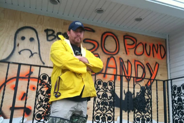 Joe Rullo outside his North Wildwood bar, where he has a few choice words for this gal named Sandy. (Jason Nark / Staff)