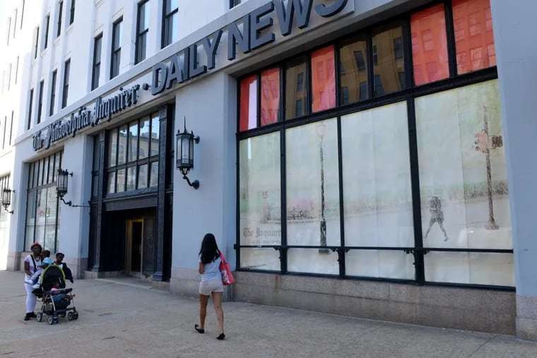 Fading billboard-sized photos by Inquirer photographer Tom Gralish still graced the giant windows in a September 2014 photo of the front of the Inquirer-Daily News building at 400 N. Broad Street. The newspapers had moved out of the building two years earlier.