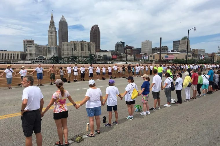 About 2,000 peaceful protesters held hands in silence on the Hope Memorial Bridge for 30 minutes Sunday in Cleveland. The Republican National Convention kicks off on Monday.