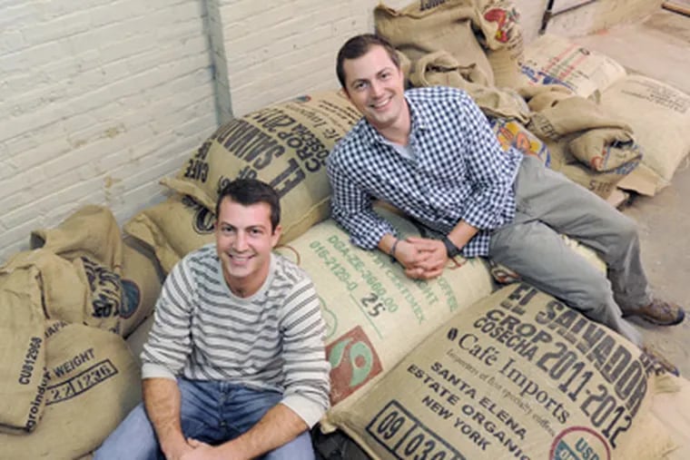 Chris (left) and Tom Molieri, owners of Green Street Coffee Roasters, sit among bags of green coffee beans. (Clem Murray / Staff Photographer)
