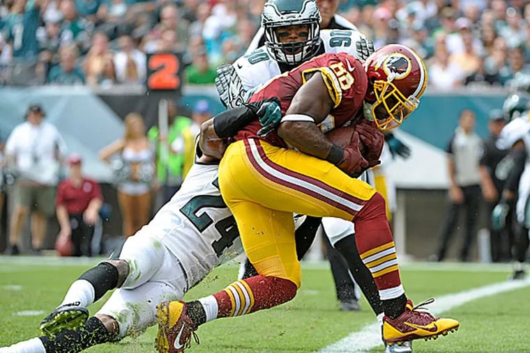 Redskins wide receiver Pierre Garcon scores on a touchdown catch against Eagles cornerback Bradley Fletcher and linebacker Marcus Smith  in the first quarter. (Eric Hartline/USA Today Sports)