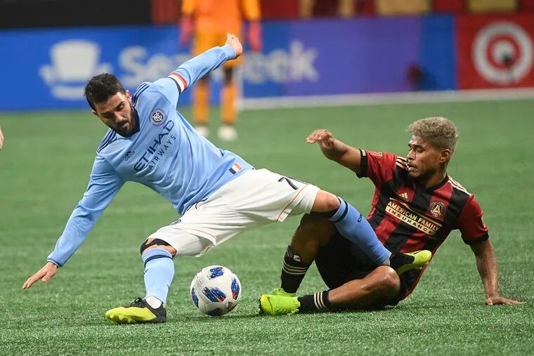 New York City forward David Villa and Atlanta United forward Josef Martinez battle for control of the ball during the first half.