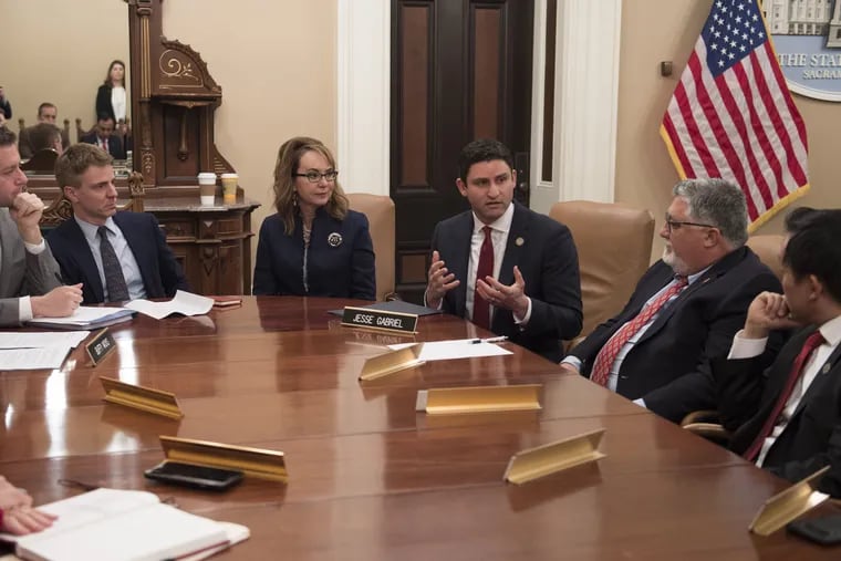 Former Rep. Gabby Giffords (center) and California State Assemblyman Jesse Gabriel (right) speak with other lawmakers about gun violence prevention legislation in Sacramento, Calif., on February 4.