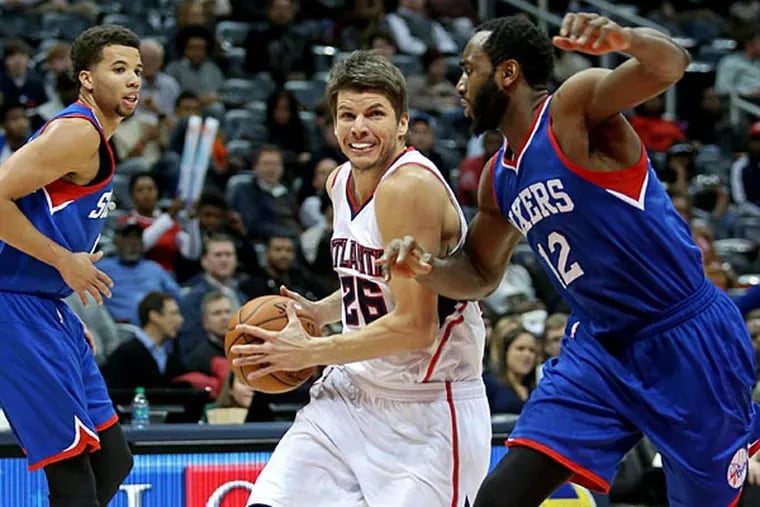 Atlanta Hawks guard Kyle Korver (26) drives against Philadelphia 76ers forward Luc Richard Mbah a Moute (12) in the fourth quarter of their game at Philips Arena. The Hawks won 95-79. (Jason Getz/USA Today)