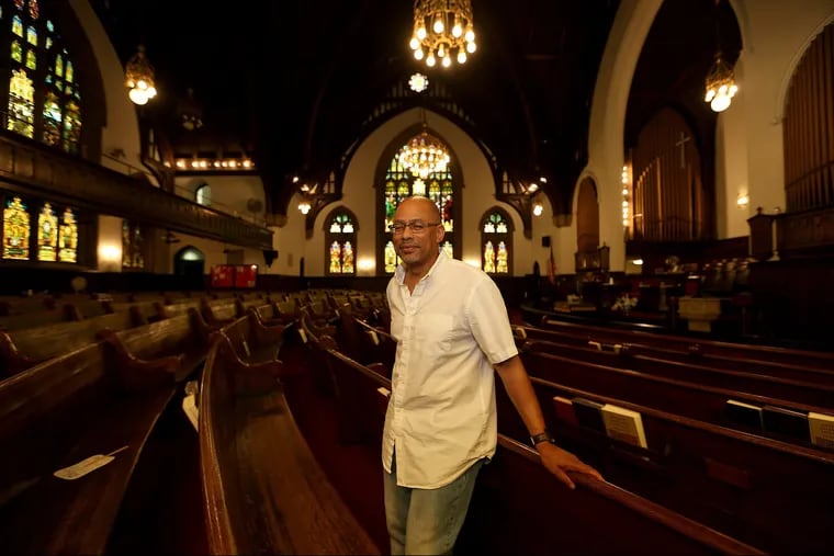 Rev. David Brown poses inside the Wharton-Wesley United Methodist Church in Philadelphia, PA on July 13, 2018. The church's debt to the Eastern Conference of the United Methodist Church has been forgiven as part of admission by the local denomination that the African American churches in the conference were unfairly saddled with old buildings formerly occupied by predominantly white churches, thus burdening the African American congregations with the responsibility for the upkeep of deteriorating structures, sapping church finances. That responsibility resulted in churches being unable to keep up with with expected contributions to the local and national denomination. DAVID MAIALETTI / Staff Photographer