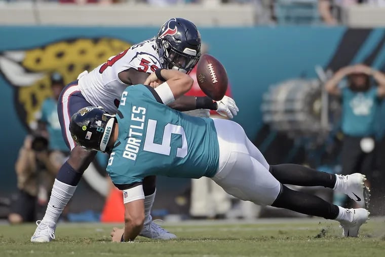 Jacksonville quarterback Blake Bortles fumbles the ball as he is hit by Houston linebacker Whitney Mercilus. The Jags have lost three in a row and play the Eagles next Sunday in London.