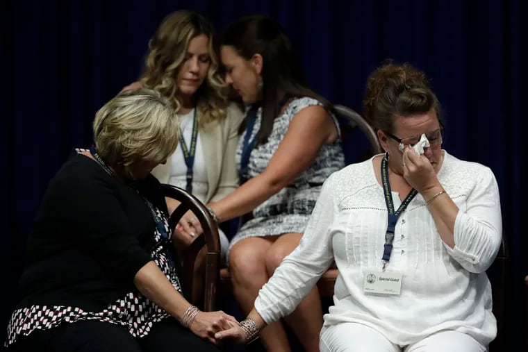Victims of clergy sexual abuse, or their family members, react as Pennsylvania Attorney General Josh Shapiro speaks during a news conference at the state Capitol in Harrisburg in August 2018.