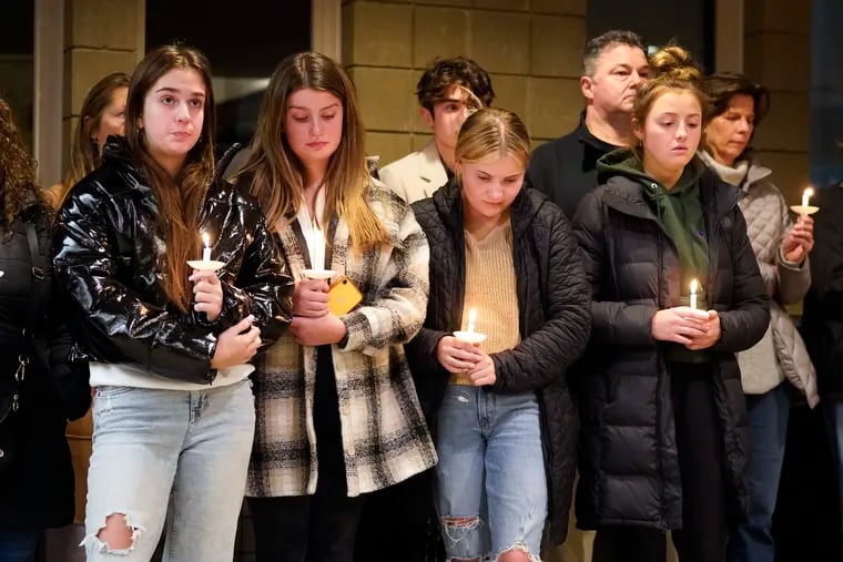 Students attend a vigil at LakePoint Community Church in Oxford, Mich., Tuesday, Nov. 30, 2021. Authorities say a 15-year-old sophomore opened fire at Oxford High School, killing three students and wounding eight other people, including a teacher.