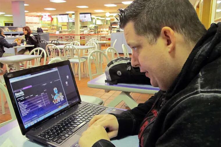 Joseph Brennen tests Harrah's online casino from a rest area in Egg Harbor Township, N.J., last week. The state's Internet gambling system officially launches Tuesday, after a five-day test period. (AP Photo)