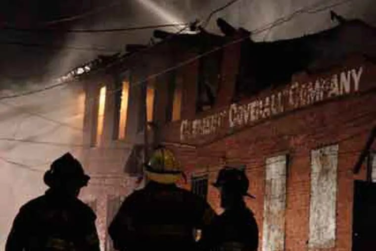A two-alarm fire Tuesday night at the old Clement Coverall Co. plant in Camden was started by a squatter. (Elizabeth Robertson / Staff Photographer)