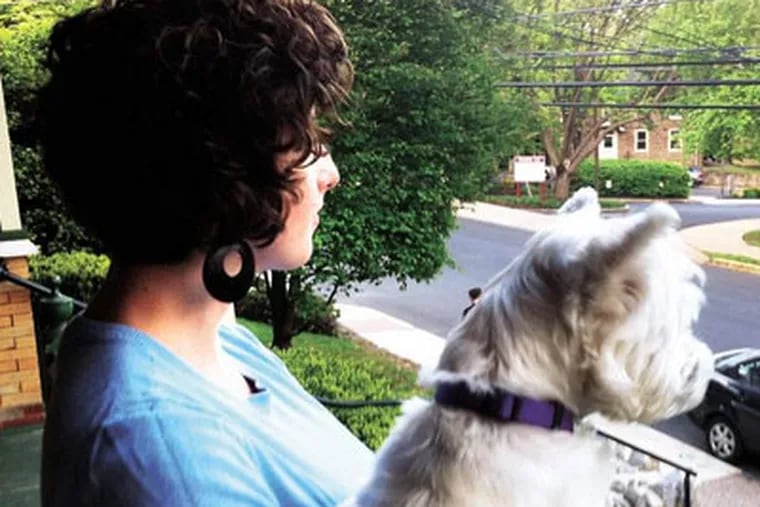 R. Elizabeth Furey with her dog, Lily, on her front porch in Doylestown.  She's three credits shy of her master's degree in clinical and counseling psychology. (Ronnie Polaneczky / Daily News Staff)