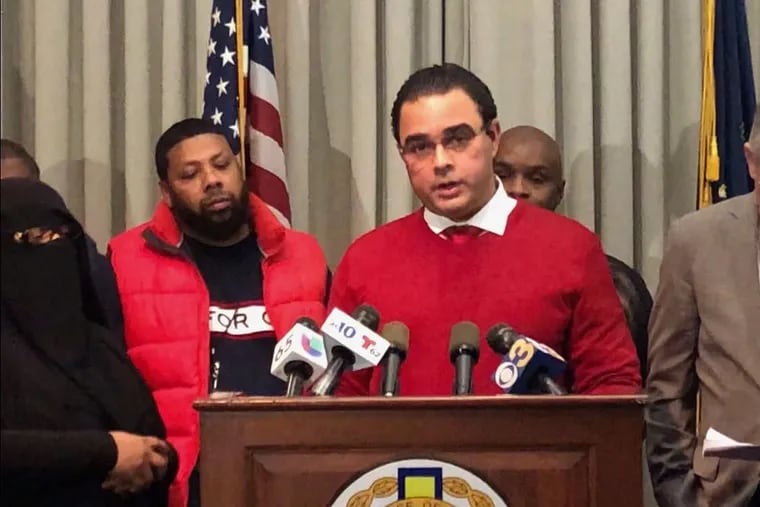 Miguel Peralta, a representative from the Dominican Grocery Store Association of Philadelphia, pledges to stop selling toy guns at a press conference held by the DA's Office.