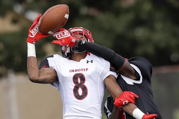 Imhotep Charter’s Yusuf Terry (8) makes the catch over Northeast’s Alex Martin in a Public League Independence Division game this season.