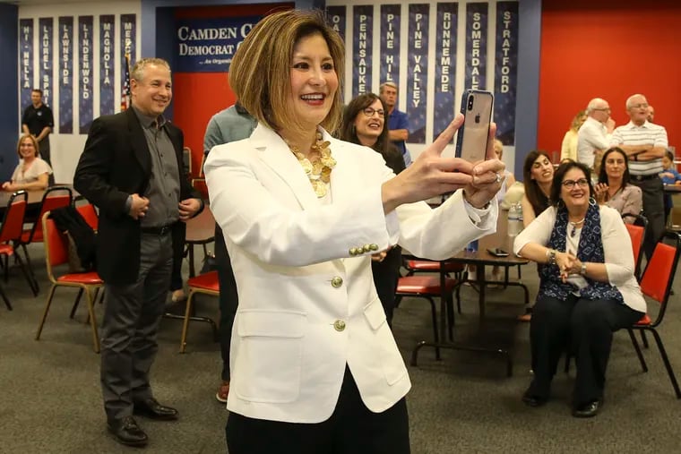 Cherry Hill Mayoral candidate Susan Shin Angulo takes a photo of election results coming in at Camden County Democratic Committee in Cherry Hill, Tuesday, June 4, 2019.