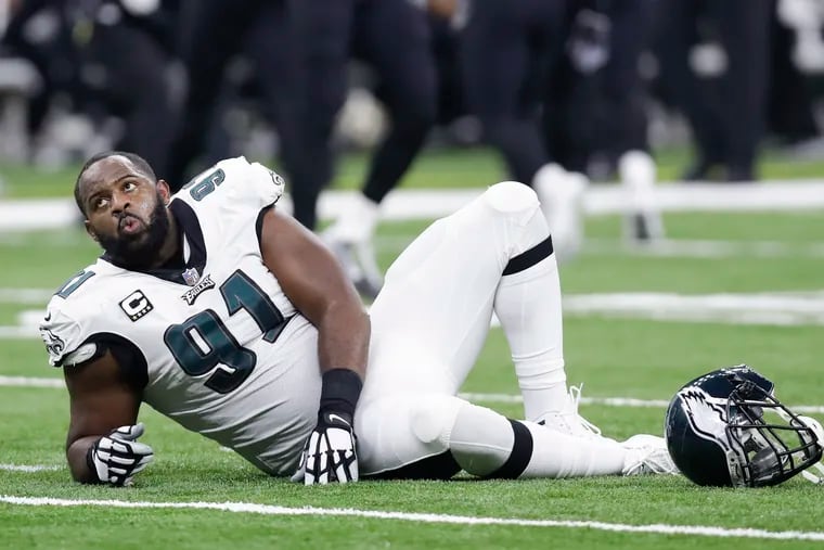 Fletcher Cox lays on the turf after suffering an injury on the Saints' fake-punt play.