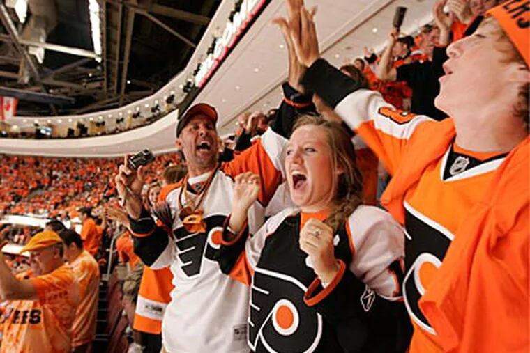 Flyers fans in the 200-level celebrate a goal in the first period of Game 4 of the Stanley Cup Finals. (Michael Bryant / Staff Photographer)