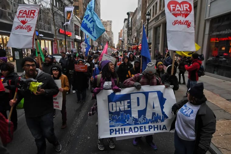 Fast-food and retail workers marched near City Hall in February 2018 as part of the launch of a local effort to fight for “Fair Workweek” legislation. It's one of the cutting-edge labor protections that the city has passed in the last year.