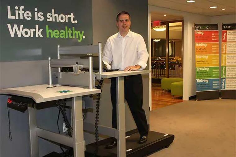 Dan Calista, CEO of the health-care-consulting firm Vynamic, walks the walk - with a treadmill at a desk. (Steven M. Falk / Staff Photographer)