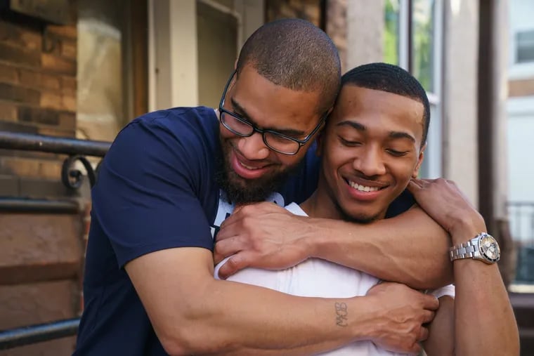 Exoneree Terrance Lewis, and his son Zahaire Lewis, shown here at Terrance's Aunts house, after Terrance was released from prison earlier this afternoon, in North Philadelphia, May 22, 2019.