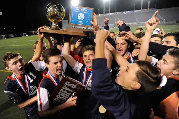 Members of the Central Bucks East team celebrate their state championship Saturday night in Hershey.